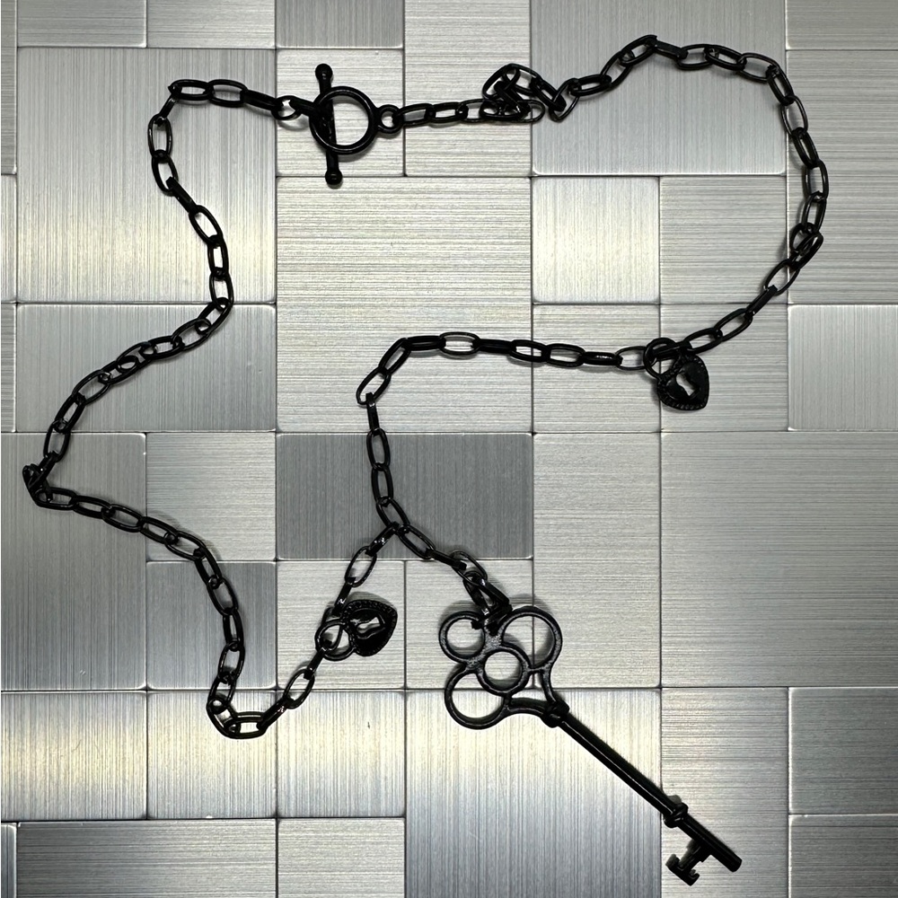 4 for $20! Black metal key pendant with 2 heart locks on a black metal chain.